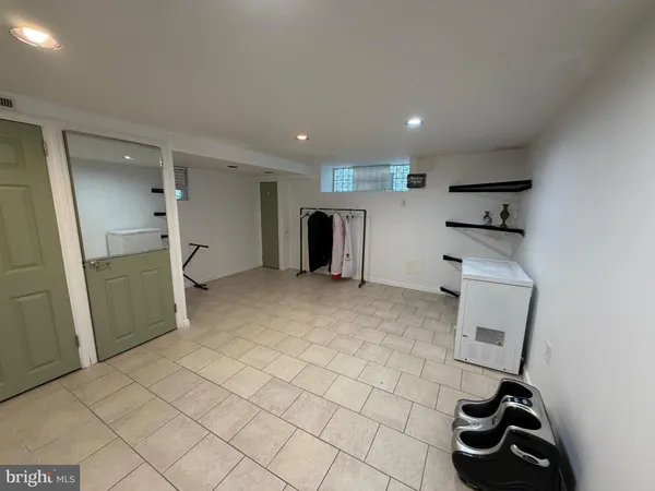 a kitchen with a refrigerator and white cabinets