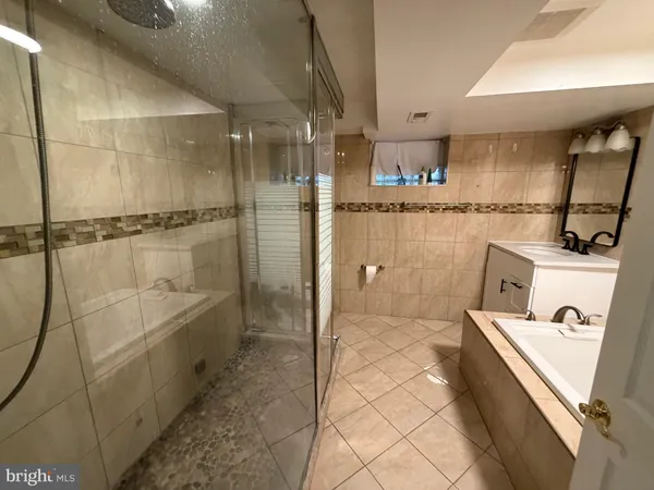 a bathroom with a bathtub and shower