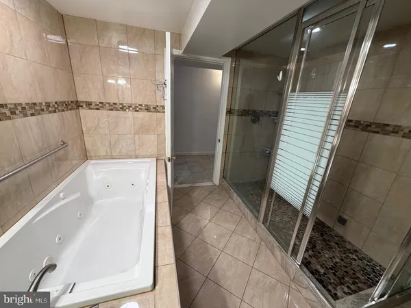 a bathroom with a bathtub and a shower