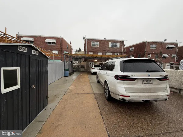 a view of a cars park in front of a building
