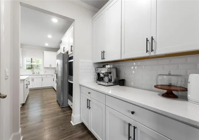 a kitchen with sink cabinets and refrigerator