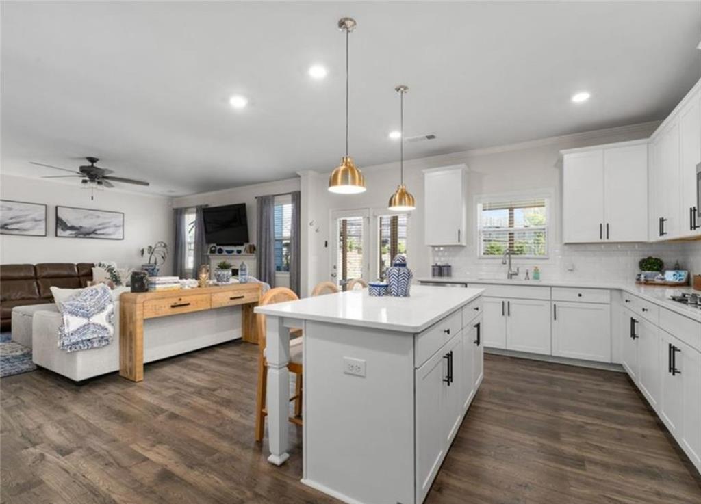 146 Citrine Way Acworth, GA 30101 - Photo 12 of 48 a large kitchen with white cabinets and wooden floors