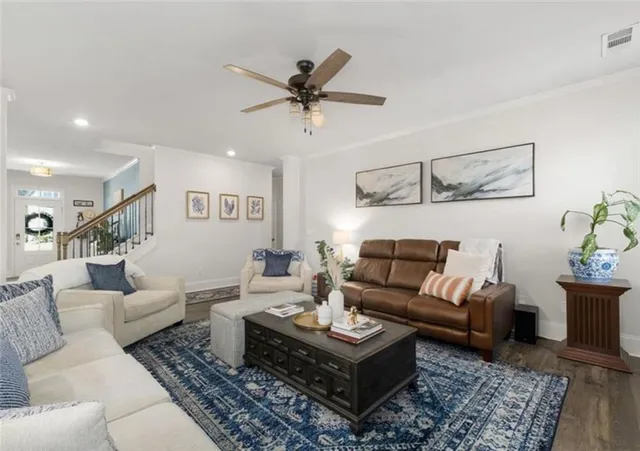 a living room with furniture and wooden floor