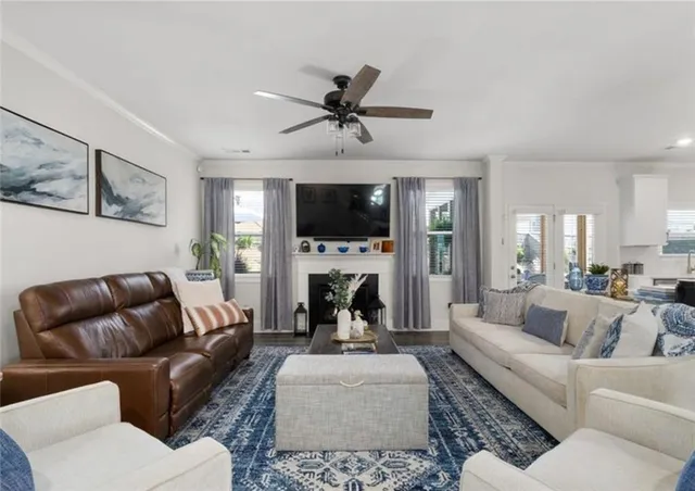 a living room with furniture a fireplace and a flat screen tv