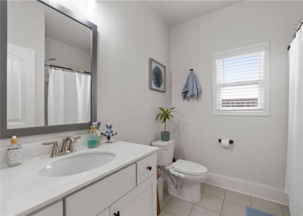 146 Citrine Way Acworth, GA 30101 - Photo 19 of 48 a bathroom with a granite countertop toilet a sink and a mirror
