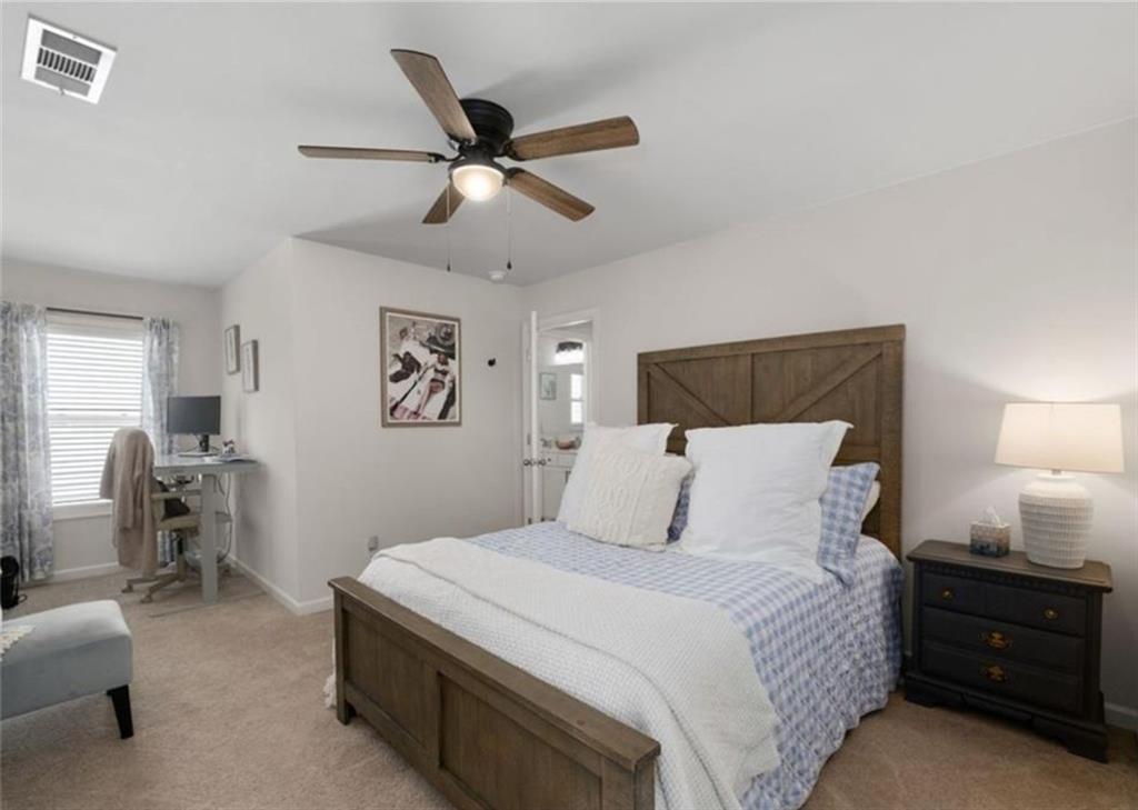 146 Citrine Way Acworth, GA 30101 - Photo 24 of 48 a bedroom with a bed and wooden floor