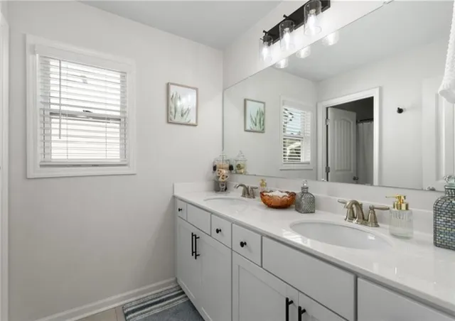 a bathroom with a sink a stove and a mirror