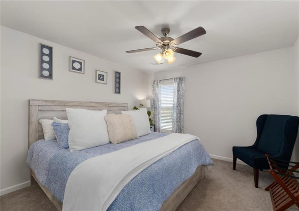 146 Citrine Way Acworth, GA 30101 - Photo 26 of 48 a bedroom with a large bed and a chair