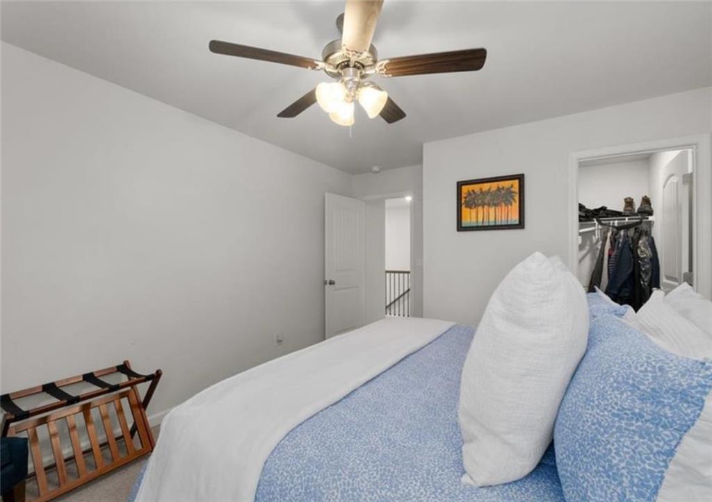 146 Citrine Way Acworth, GA 30101 - Photo 27 of 48 a bedroom with a bed and a chandelier