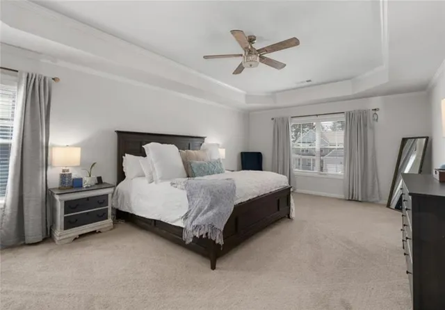 a spacious bedroom with a bed a chandelier and a walk in closet