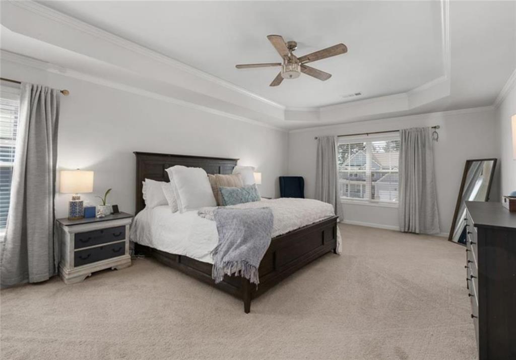 146 Citrine Way Acworth, GA 30101 - Photo 31 of 48 a spacious bedroom with a bed a chandelier and a walk in closet