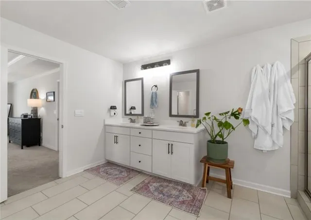 a spacious bathroom with a sink and a mirror