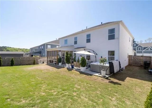 a view of a house with backyard and sitting area