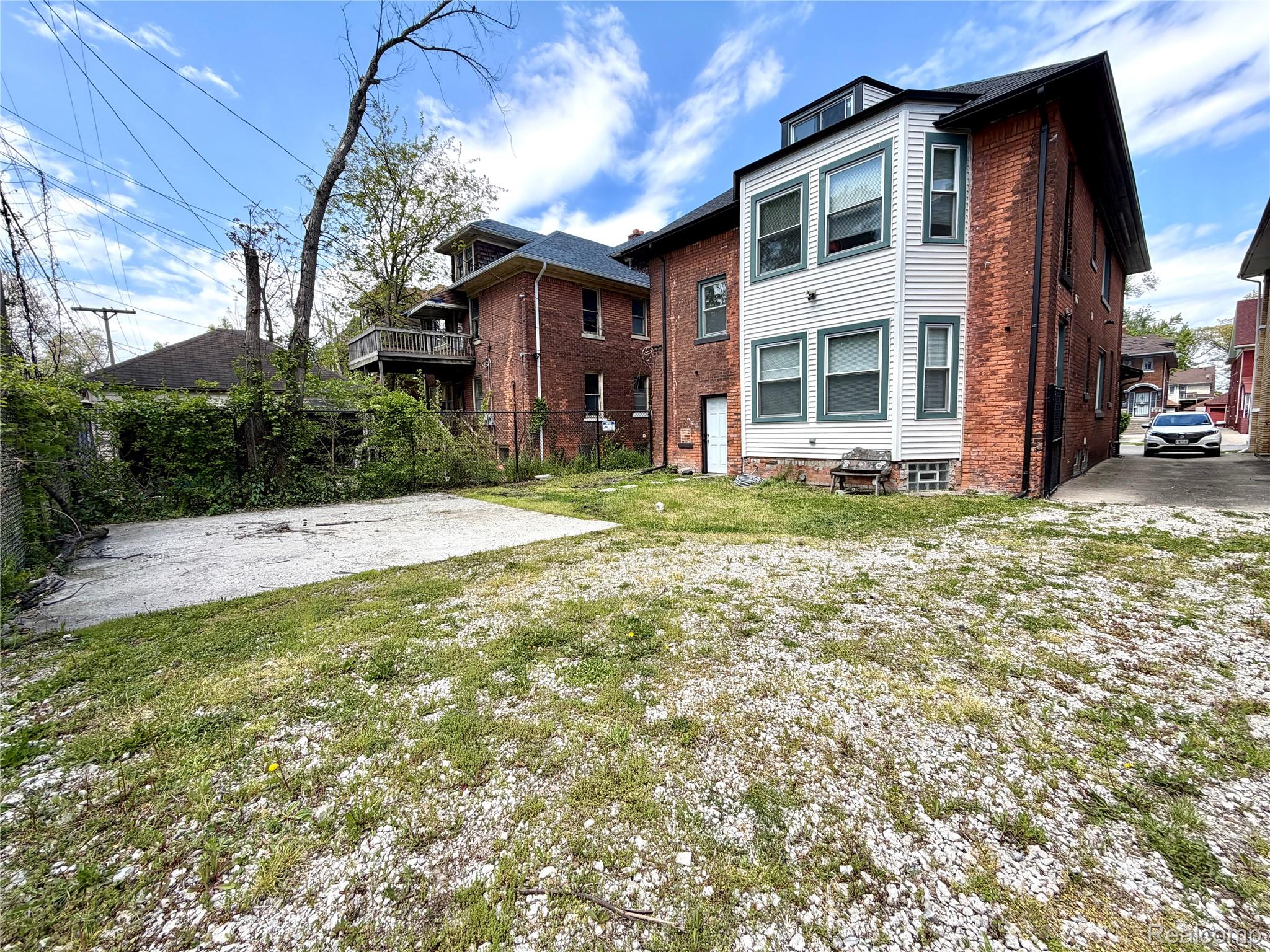 2045 Calvert Avenue Detroit, MI 48206 - Photo 36 of 41 Back of property with brick siding and a balcony