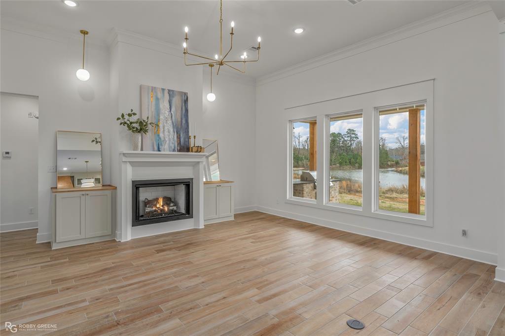 75 Turtle Creek Drive Benton, LA 71006 - Photo 4 of 32 an empty room with wooden floor fireplace and windows