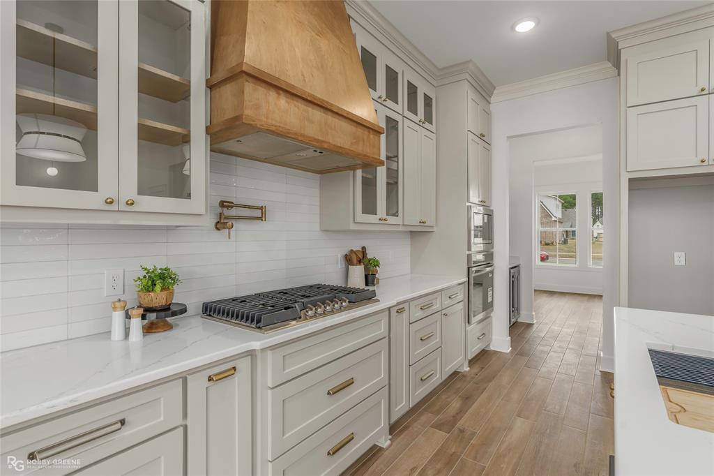 75 Turtle Creek Drive Benton, LA 71006 - Photo 6 of 32 a kitchen with stainless steel appliances white cabinets and wooden floor