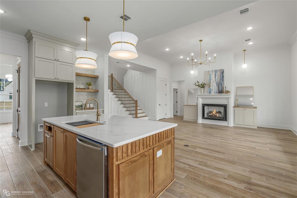 75 Turtle Creek Drive Benton, LA 71006 - Photo 8 of 32 a kitchen with a stove a sink a refrigerator and a fireplace