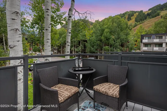 a view of a chairs and table in a patio