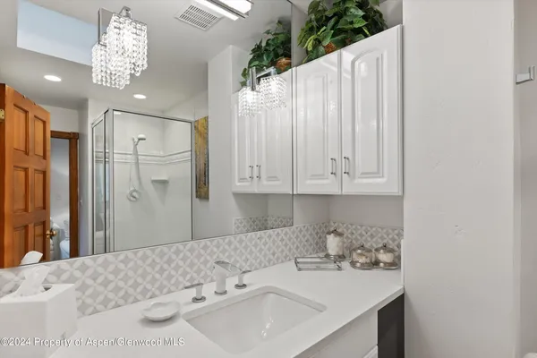 a bathroom with a sink a vanity and a mirror