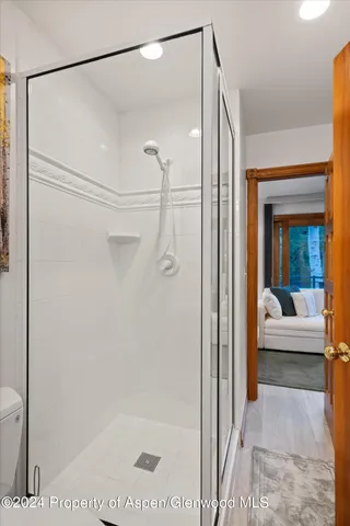 a bathroom with a shower and a glass door