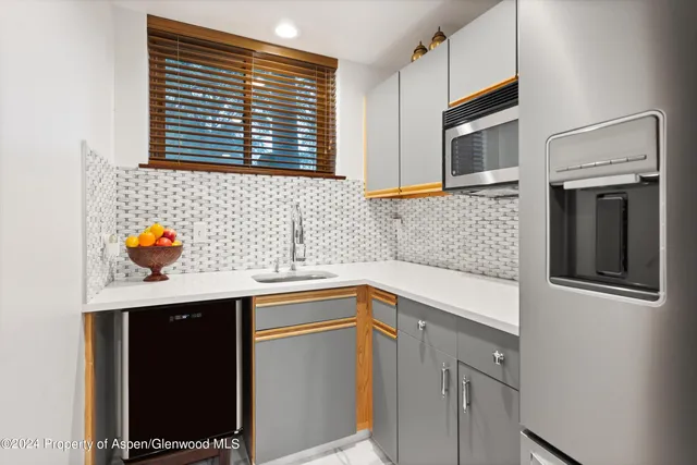 a kitchen with stainless steel appliances granite countertop a sink and a microwave