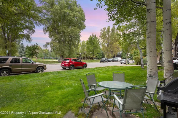 a view of backyard with seating and green space