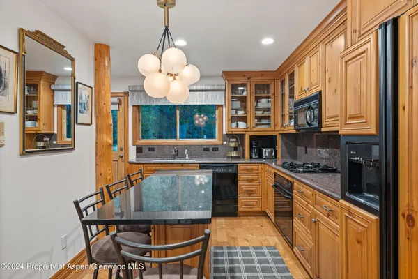 a kitchen with stainless steel appliances granite countertop a stove and cabinets