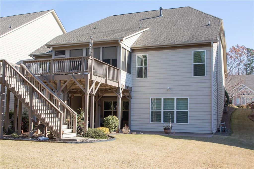 3746 Cypresswood Point Southwest Gainesville, GA 30504 - Photo 2 of 4 a view of a house with a yard outdoor seating area and barbeque oven