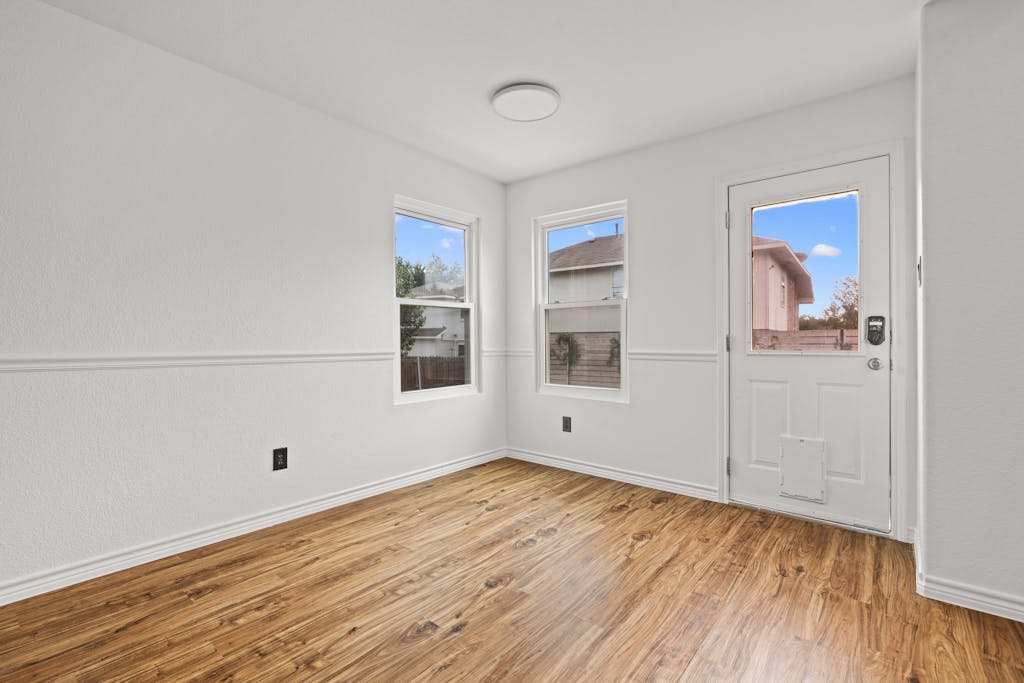 915 Satellite View Round Rock, TX 78665 - Photo 16 of 36 a view of empty room with wooden floor and fan