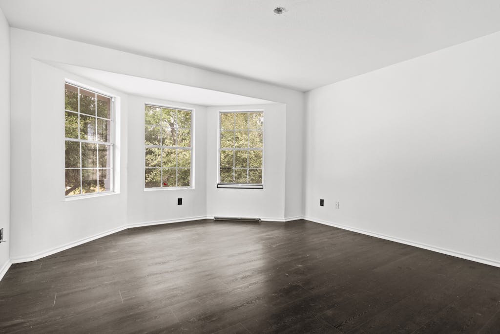 915 Satellite View Round Rock, TX 78665 - Photo 23 of 36 an empty room with wooden floor and windows
