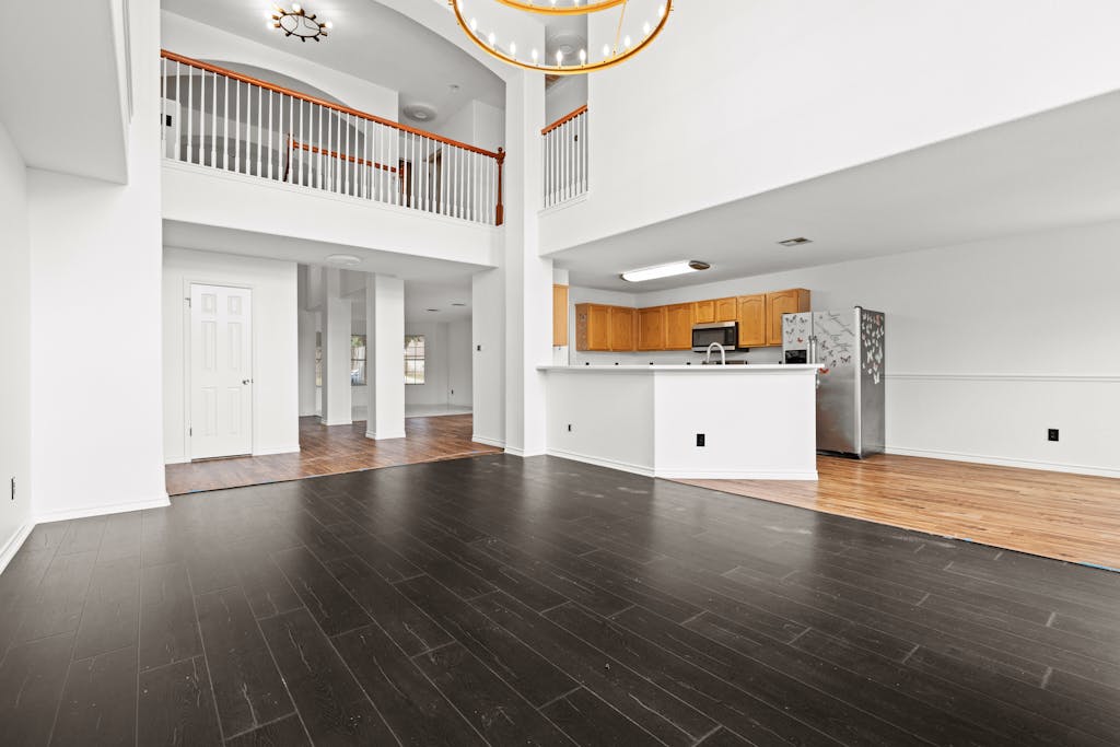 915 Satellite View Round Rock, TX 78665 - Photo 9 of 36 an empty room with wooden floor and windows