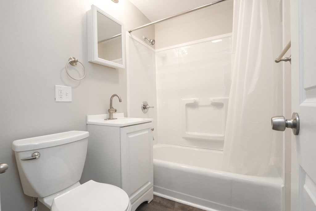 40 Vincent Street Springfield, MA 01129 - Photo 18 of 35 a white toilet sitting next to a bath tub