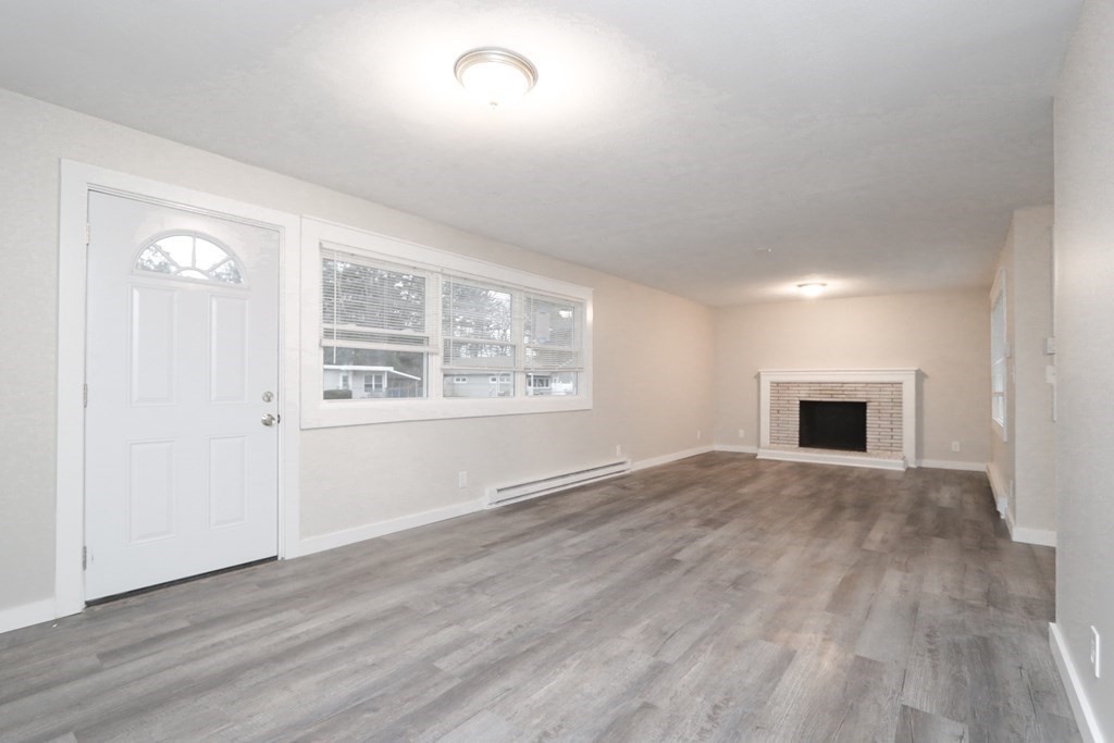 40 Vincent Street Springfield, MA 01129 - Photo 2 of 35 an empty room with wooden floor and windows