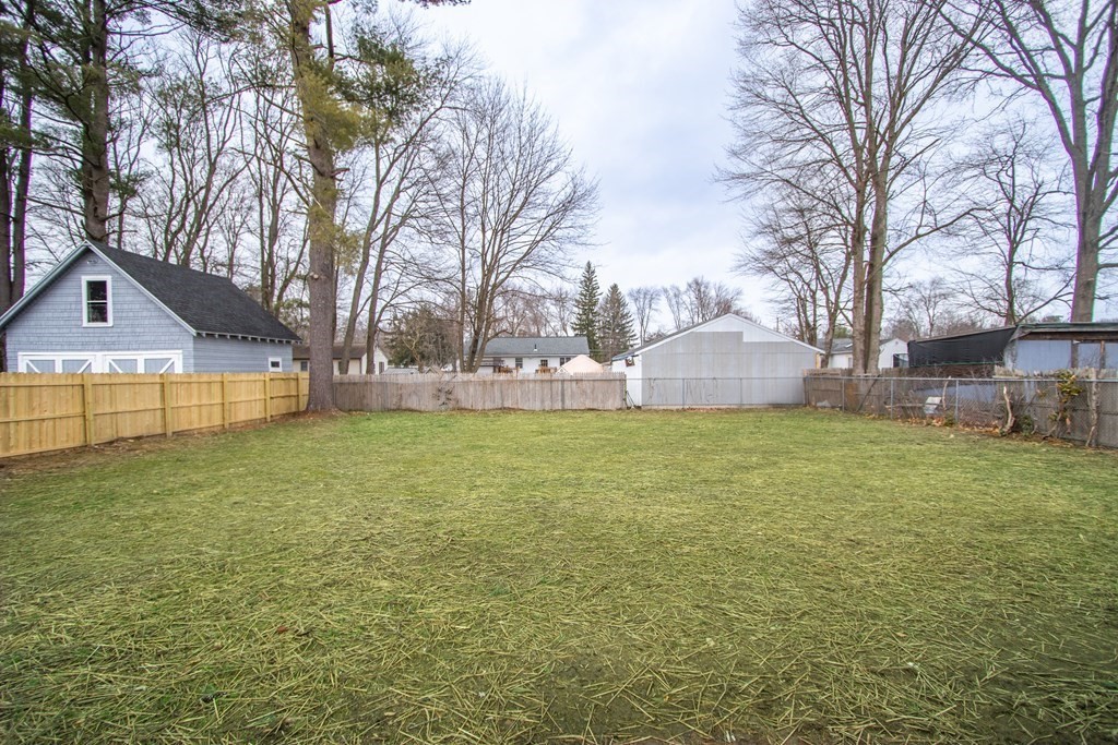 40 Vincent Street Springfield, MA 01129 - Photo 32 of 35 a view of a yard with a house and a large tree