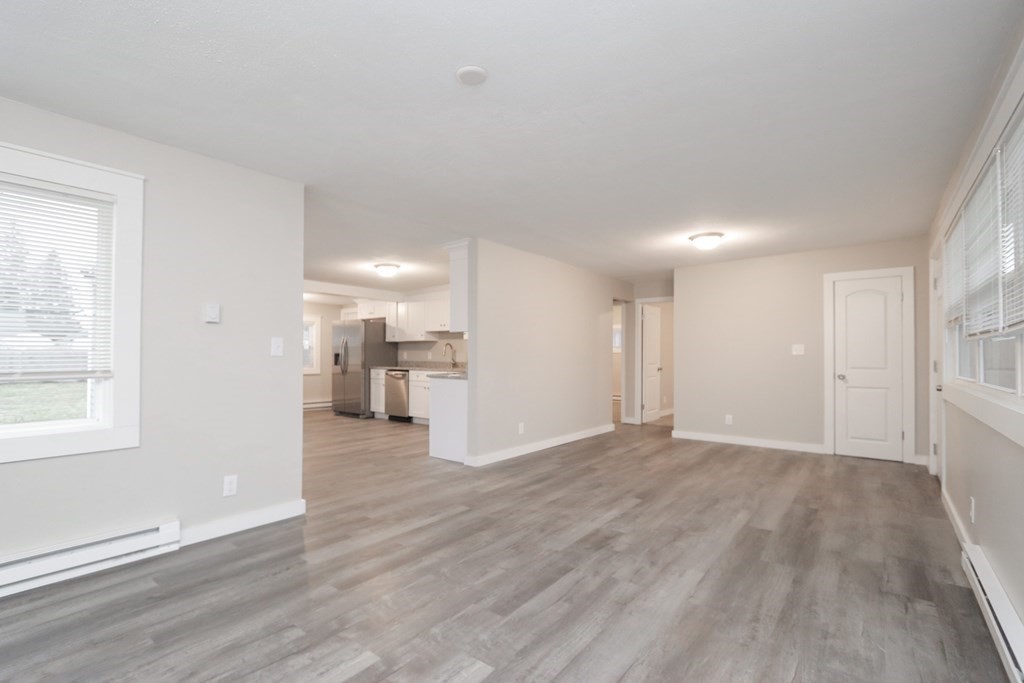 40 Vincent Street Springfield, MA 01129 - Photo 6 of 35 a view of a big room with wooden floor and a kitchen