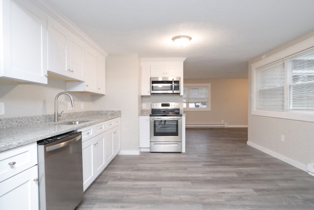 40 Vincent Street Springfield, MA 01129 - Photo 10 of 35 a kitchen with stainless steel appliances a stove sink and cabinets