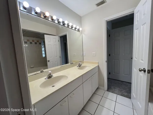 a bathroom with a sink double vanity and a mirror