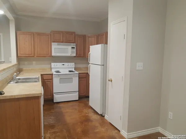 a kitchen with a stove sink and refrigerator