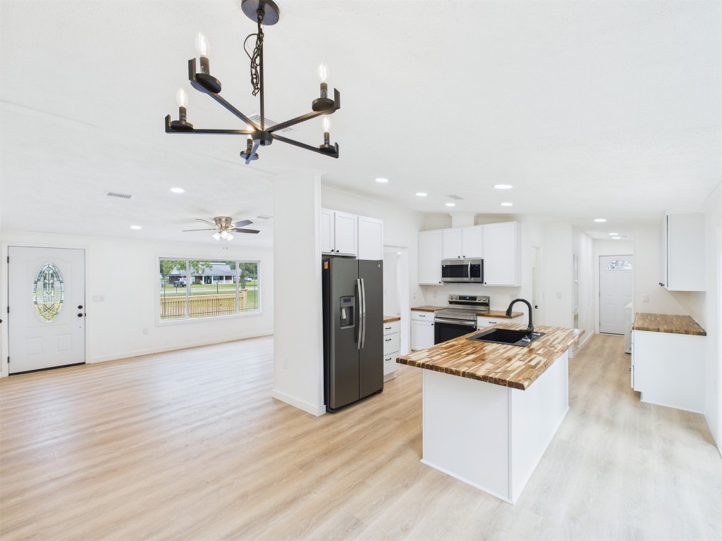 85490 Alene Road Yulee, FL 32097 - Photo 12 of 49 a kitchen with a refrigerator a stove top oven a counter space and wooden floor