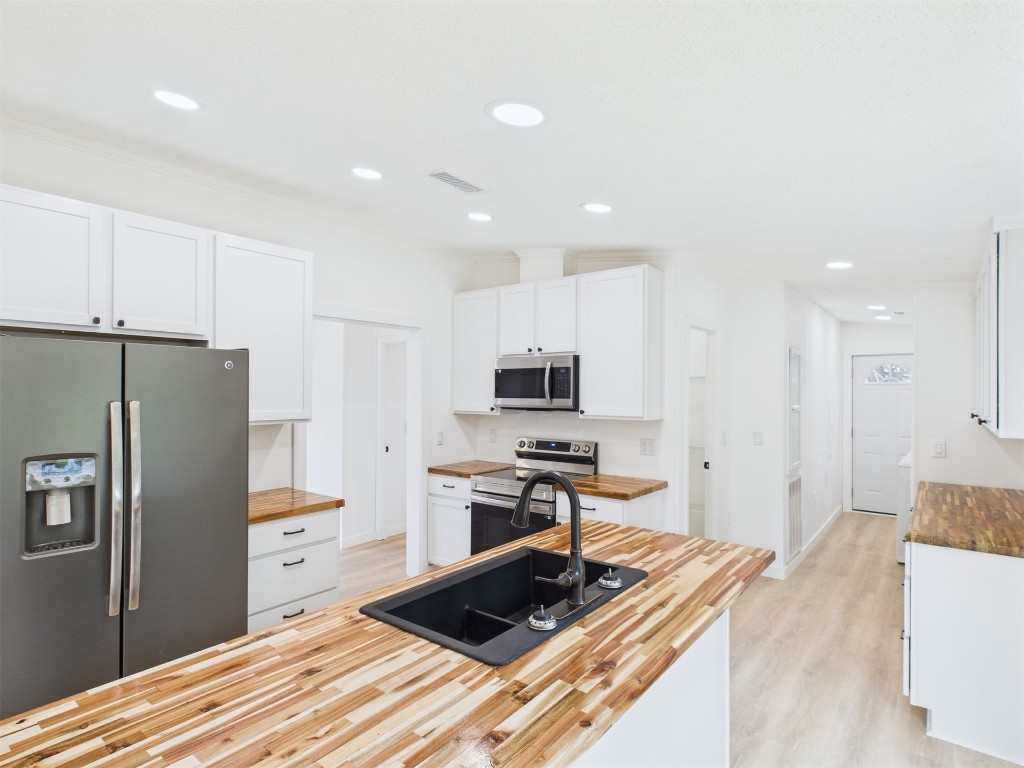 85490 Alene Road Yulee, FL 32097 - Photo 13 of 49 a kitchen with stainless steel appliances a refrigerator and a stove top oven