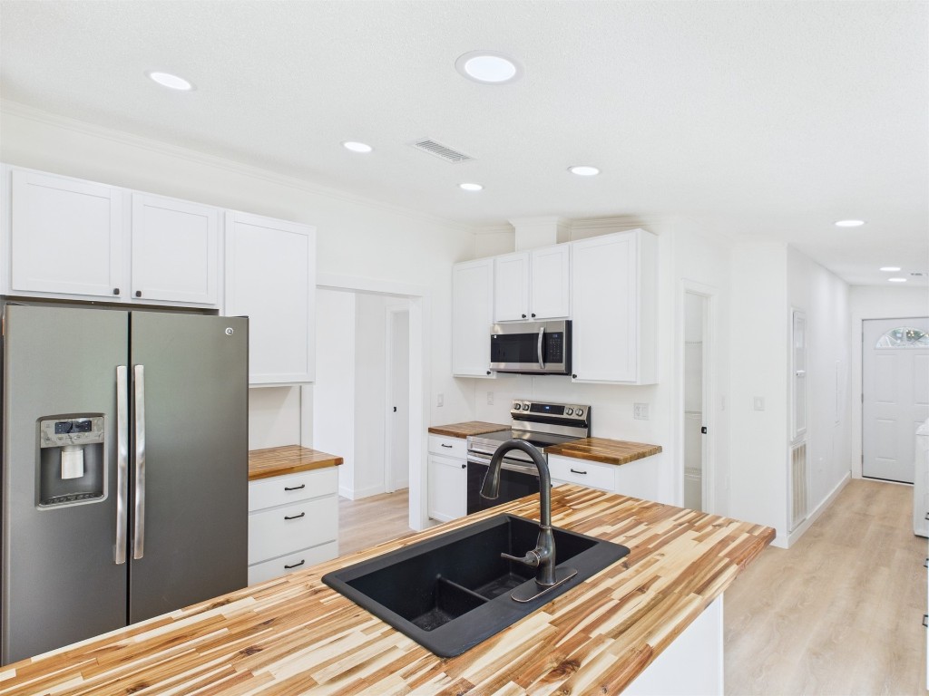 85490 Alene Road Yulee, FL 32097 - Photo 14 of 49 a kitchen with stainless steel appliances a refrigerator stove and microwave