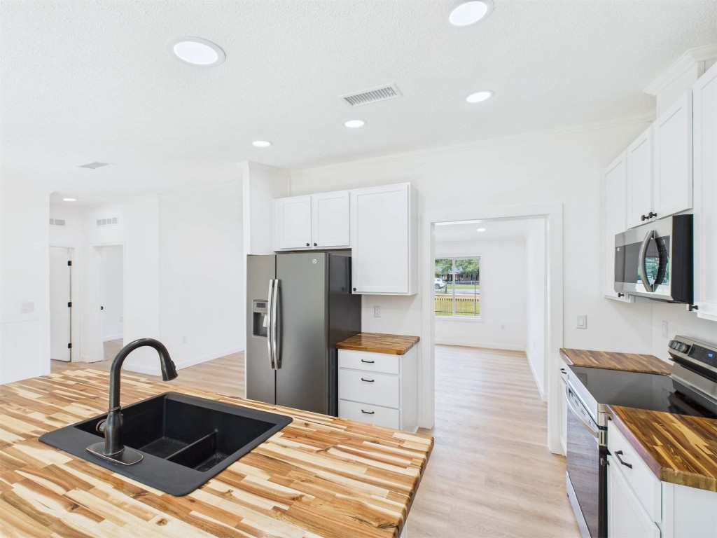 85490 Alene Road Yulee, FL 32097 - Photo 15 of 49 a kitchen with stainless steel appliances granite countertop a sink a stove a refrigerator cabinets and living room view