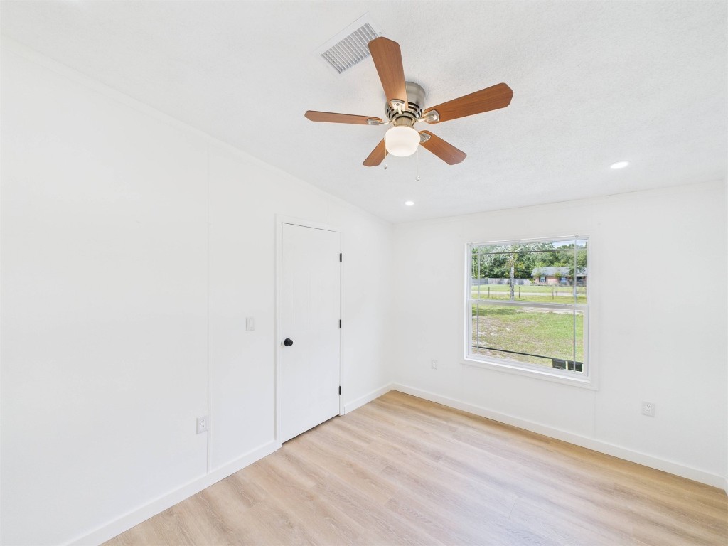 85490 Alene Road Yulee, FL 32097 - Photo 26 of 49 an empty room with wooden floor fan and windows