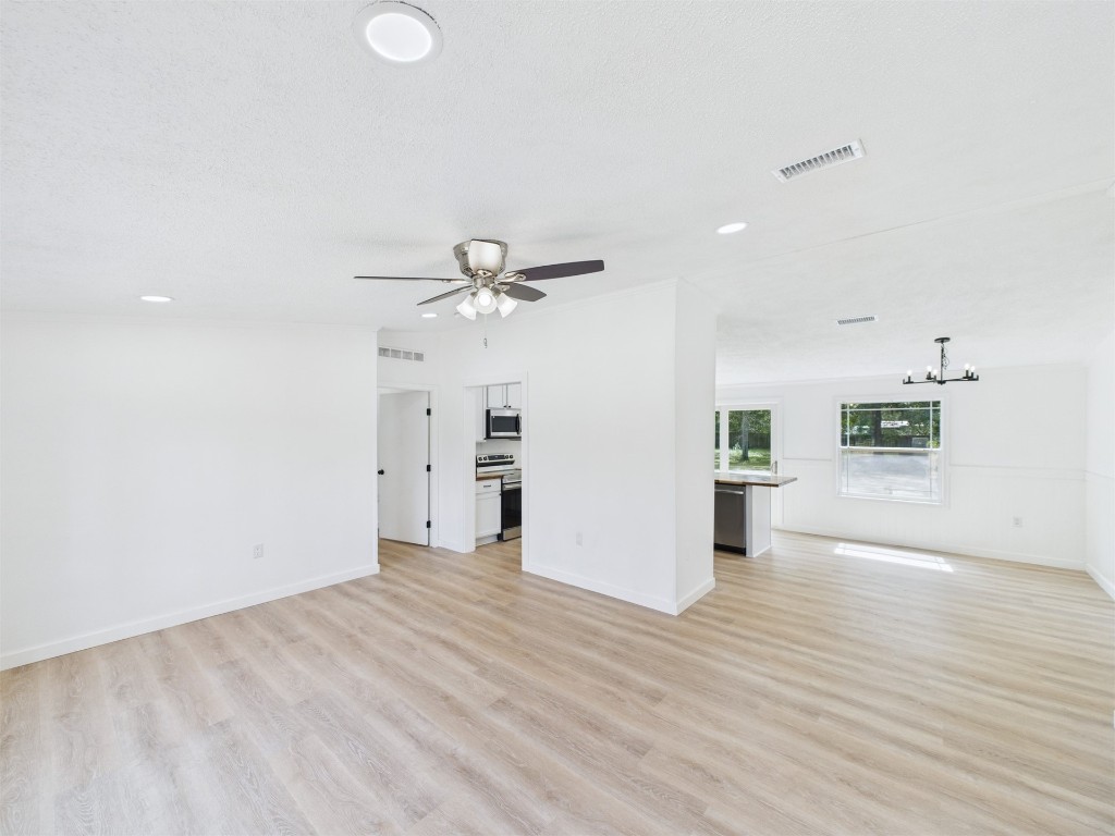 85490 Alene Road Yulee, FL 32097 - Photo 9 of 49 a view of a big room with wooden floor and windows