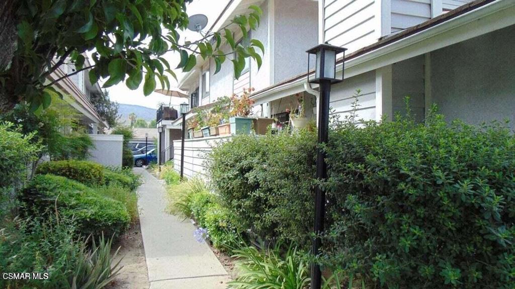 2388 Royal Avenue, Unit 26 Simi Valley, CA 93065 - Photo 2 of 11 a view of a multi story building center with plants and large trees