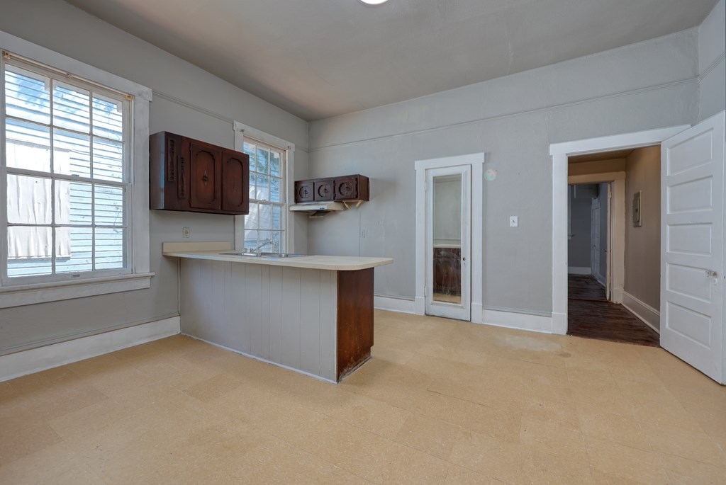 2904 Beacon Avenue Columbus, GA 31904 - Photo 12 of 39 an empty room with a fireplace and a window