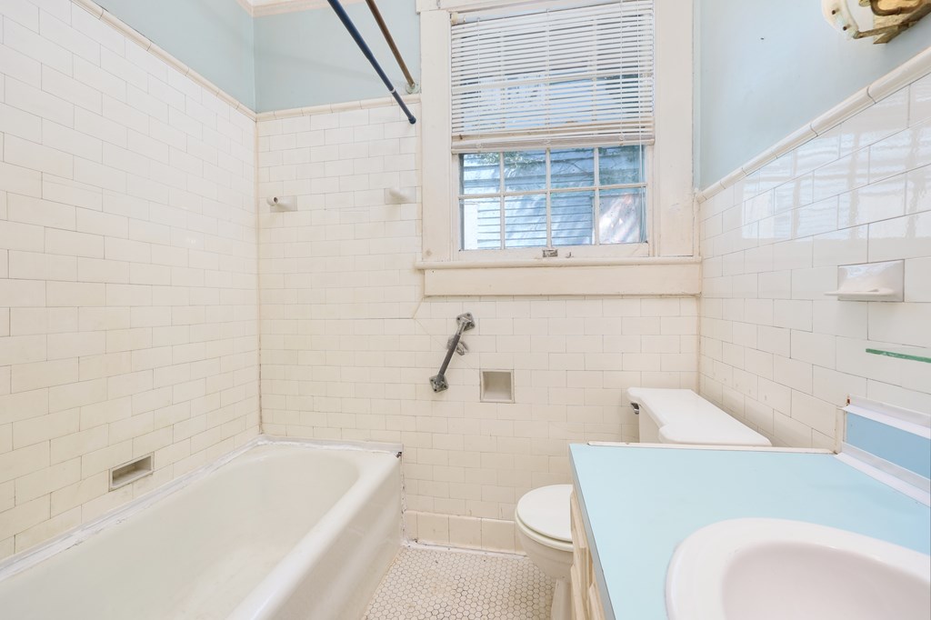 2904 Beacon Avenue Columbus, GA 31904 - Photo 16 of 39 a bathroom with a bathtub and window