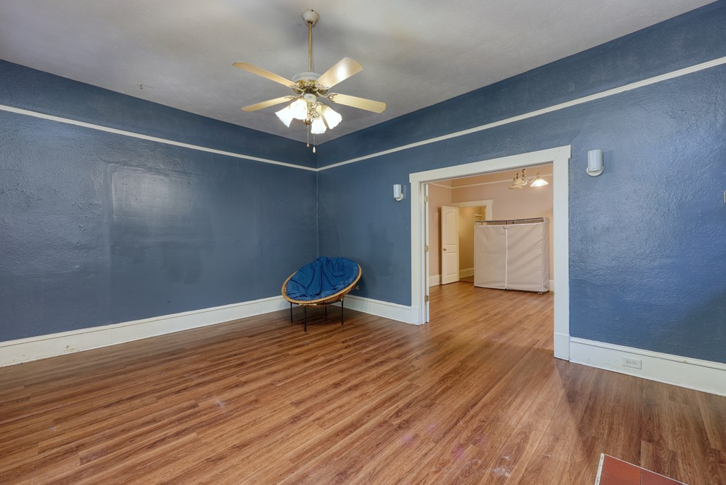 2904 Beacon Avenue Columbus, GA 31904 - Photo 21 of 39 a view of an empty room with wooden floor and a chandelier fan
