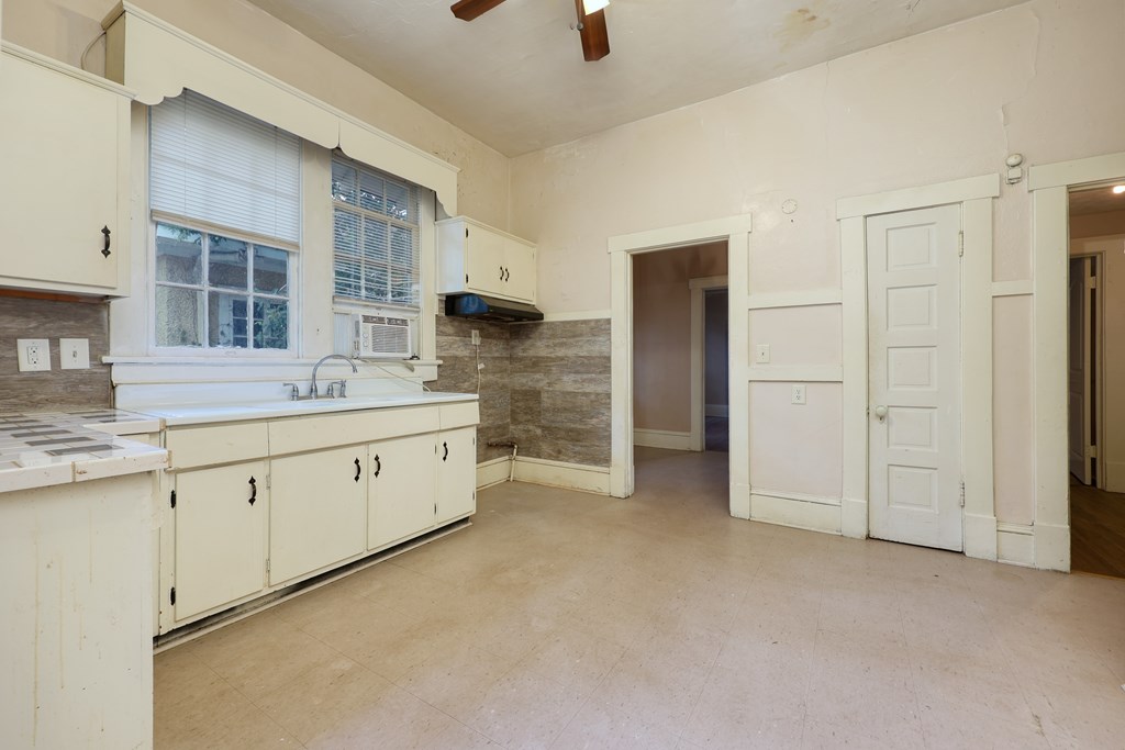 2904 Beacon Avenue Columbus, GA 31904 - Photo 30 of 39 a large white kitchen with a sink stainless steel appliances and cabinets