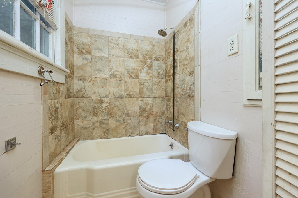2904 Beacon Avenue Columbus, GA 31904 - Photo 32 of 39 a white toilet and tub sitting next to a bathroom sink